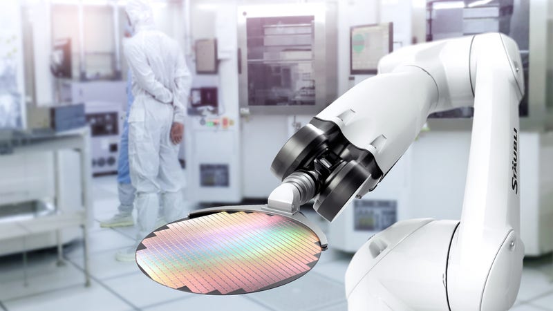 Cleanroom robot handles a wafer in a semiconductor fabrication plant (FAB).